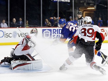 New York Islanders center Brock Nelson (29) scores a goal past Ottawa Senators goalie Mike Condon in front of Senators defenseman Andreas Englund (39) in the second period of an NHL hockey game, Sunday, April 9, 2017, in New York.
