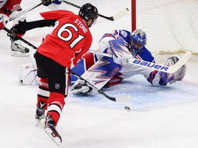 New York Rangers goalie Henrik Lundqvist sprawls to make a save on the Ottawa Senators' Mark Stone in Game 1.