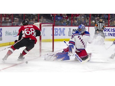 New York Rangers goalie Henrik Lundqvist makes a save against the Ottawa Senators' Mike Hoffman.