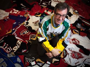 Ottawa Mayor, Jim Watson, poses with his collection of sports jerseys in his office which he has amassed during his time as mayor as gifts and through bets with the mayors of other cities.