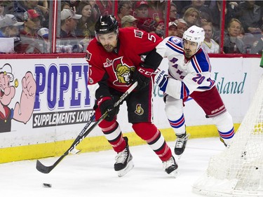 Ottawa Senators #5 Cody Ceci gets the puck from New York Rangers #20 Chris Kreider during the second period of play at Canadian Tire Centre Saturday April 8, 2017.