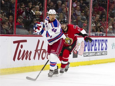 Ottawa Senators #67 Ben Harpur tries to catch New York Rangers #40 Michael Grabner during the second period of play at Canadian Tire Centre Saturday April 8, 2017.