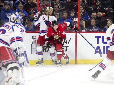 Ottawa Senators #7 Kyle Turris and New York Rangers #4 Adam Clendening collide on the boards during the first period of play at Canadian Tire Centre Saturday April 8, 2017.