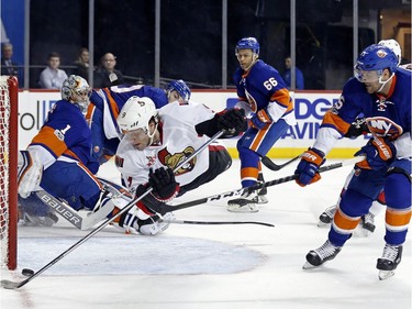Senators winger Bobby Ryan (9) flies through the air after being tripped by Islanders defenceman Adam Pelech in front of goalie Thomas Greiss (1) in the first period of Sunday's game. Ryan didn't score on this play, but did score a goal in the second period.