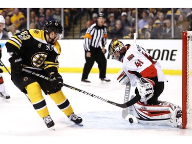 Craig Anderson of the Ottawa Senators stops Brad Marchand during the first period.