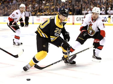 Riley Nash of the Boston Bruins skates against Cody Ceci of the Ottawa Senators  during the first period.