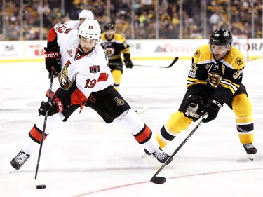 Derick Brassard of the Ottawa Senators skates against Patrice Bergeron.