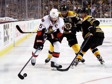 BOSTON, MA - APRIL 23:  Erik Karlsson #65 of the Ottawa Senators skates against David Pastrnak #88 and Patrice Bergeron #37 of the Boston Bruins during overtime in Game Six of the Eastern Conference First Round during the 2017 NHL Stanley Cup Playoffs at TD Garden on April 23, 2017 in Boston, Massachusetts. The Senators defeat the Bruins 3-2.