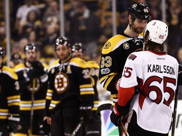BOSTON, MA - APRIL 23:  Zdeno Chara #33 of the Boston Bruins talks with Erik Karlsson #65 of the Ottawa Senators after the Senators defeat the Bruins 3-2 in overtime of Game Six of the Eastern Conference First Round during the 2017 NHL Stanley Cup Playoffs at TD Garden on April 23, 2017 in Boston, Massachusetts.