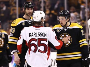BOSTON, MA - APRIL 23:  Erik Karlsson #65 of the Ottawa Senators talks with Charlie McAvoy #73 and Zdeno Chara #33 of the Boston Bruins after the Senators defeat the Boston Bruins 3-2 in overtime of Game Six of the Eastern Conference First Round during the 2017 NHL Stanley Cup Playoffs at TD Garden on April 23, 2017 in Boston, Massachusetts.