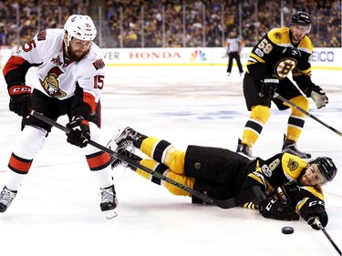 BOSTON, MA - APRIL 23:  Colin Miller #6 of the Boston Bruins slides to defend a shot from Zack Smith #15 of the Ottawa Senators during overtime of Game Six of the Eastern Conference First Round during the 2017 NHL Stanley Cup Playoffs at TD Garden on April 23, 2017 in Boston, Massachusetts. The Senators defeat the Bruins 3-2.
