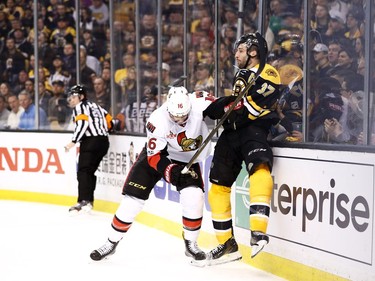 Clarke MacArthur #16 of the Ottawa Senators checks Patrice Bergeron #37 of the Boston Bruins into the boards during the first period of Game Six of the Eastern Conference First Round during the 2017 NHL Stanley Cup Playoffs at TD Garden on April 23, 2017 in Boston, Massachusetts.