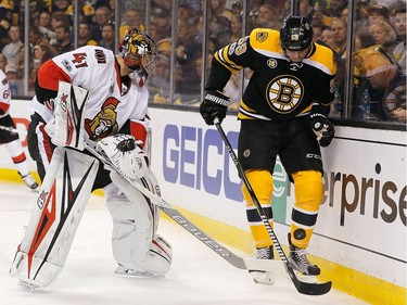 BOSTON, MA - APRIL 17: Craig Anderson #41 of the Ottawa Senators confronts Tim Schaller #59 of the Boston Bruins behind the net in the first period against the Boston Bruins in Game Three of the Eastern Conference First Round during the 2017 NHL Stanley Cup Playoffs at TD Garden on April 17, 2017 in Boston, Massachusetts.