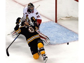 The puck trickles wide of Craig Anderson's net as Bruins forward Davis Pastrnak falls in the third period on Monday night.