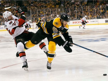 David Pastrnak #88 of the Boston Bruins and Viktor Stalberg #24 of the Ottawa Senators get tangled moving for the puck in the second period against the Boston Bruins in Game Three of the Eastern Conference First Round during the 2017 NHL Stanley Cup Playoffs at TD Garden on April 17, 2017 in Boston, Massachusetts.
