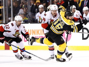 The Senators' Mark Borowiecki brings down the Bruins' David Krejci in the first period at TD Garden on April 6, 2017 in Boston, Massachusetts.