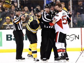 Boston's Dominic Moore and Ottawa's Tommy Wingels are separated after a fight during a game last Thursday.