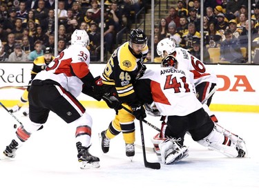 The Bruins' David Krejci is surrounded by Senators on Thursday, April 6, 2017, as Ottawa goalie Craig Anderson and teammates Fredrik Claesson and Ben Harpur focus on the puck.