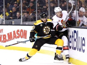 The Senators' Mark Borowiecki works along the boards against the Bruins' Kevan Miller on Thursday, April 6, 2017 at TD Garden. Borowiecki says Senators defencemen shouldn't try to change their games when Erik Karlsson is out of the lineup.