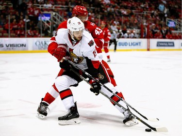 DETROIT, MI - APRIL 03:  Derick Brassard #19 of the Ottawa Senators tries to control the puck in front of Darren Helm #43 of the Detroit Red Wings during the first period at Joe Louis Arena on April 3, 2017 in Detroit, Michigan.