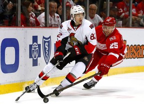 Senators forward Colin White protects the puck from the Red Wings' Mike Green (25) during last Tuesday's game at Detroit. White is expected to receive much more playing time in his second NHL game on Sunday against the Islanders.
