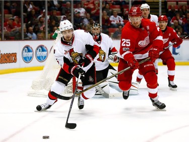 DETROIT, MI - APRIL 03:  Chris Wideman #6 of the Ottawa Senators battles for the puck with Mike Green #25 of the Detroit Red Wings during the first period at Joe Louis Arena on April 3, 2017 in Detroit, Michigan.