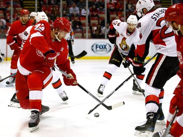 DETROIT, MI - APRIL 03:  Darren Helm #43 of the Detroit Red Wings battles for the puck with Viktor Stalberg #24 of the Ottawa Senators during the first period at Joe Louis Arena on April 3, 2017 in Detroit, Michigan.