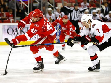 DETROIT, MI - APRIL 03:  Henrik Zetterberg #40 of the Detroit Red Wings takes a shot in front of Kyle Turris #7 of the Ottawa Senators during the first period at Joe Louis Arena on April 3, 2017 in Detroit, Michigan.