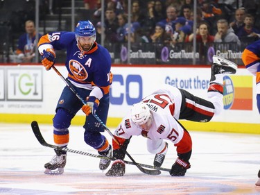 NEW YORK, NY - APRIL 09: Andrew Ladd #16 of the New York Islanders trips up Tommy Wingels #57 of the Ottawa Senators during the second period at the Barclays Center on April 9, 2017 in the Brooklyn borough of New York City.