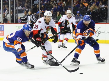 NEW YORK, NY - APRIL 09: Adam Pelech #50 and Johnny Boychuk #55 of the New York Islanders defend against Fredrik Claesson #33 of the Ottawa Senators during the second period at the Barclays Center on April 9, 2017 in the Brooklyn borough of New York City.