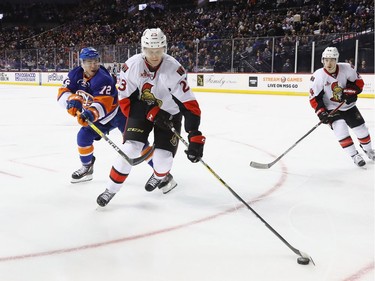 NEW YORK, NY - APRIL 09: Jyrki Jokipakka #23 of the Ottawa Senators moves the puck away from Anthony Beauvillier #72 of the New York Islanders during the second period at the Barclays Center on April 9, 2017 in the Brooklyn borough of New York City.