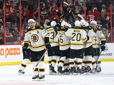 Patrice Bergeron, left, and the Boston Bruins celebrate their double-overtime win.