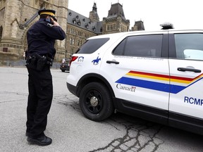 An RCMP constable is shown on Parliament Hill in Ottawa, Wednesday, April 12, 2017, wthout the yellow stripe on his pants. Mounties are protesting wages, staffing levels and working conditions by removing the yellow stripes running down the sides of their pants.