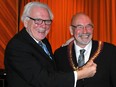 Rideau Lakes Mayor Ron Holman, who was leaving office as warden of Leeds-Grenville, gives the warden's chain to his successor, North Grenville Mayor David Gordon, in December 2014.