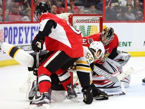 Sean Kuraly of the Boston Bruins scores on Craig Anderson as he is defended by Chris Wideman of the Ottawa Senators during second period.