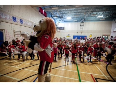 Senators mascot Spartacat pumps up students at A. Lorne Cassidy Elementary School who wave Senators towels during a rally with former players Chris Phillips and Shaun Van Allen.