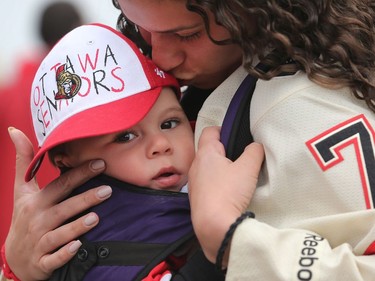 Brook Brown holds her son, Max, as she enters the CTC for Game 2.