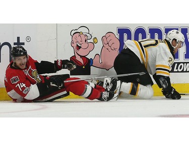 The Senators' Mark Borowiecki takes out the Bruins' Riley Nash.