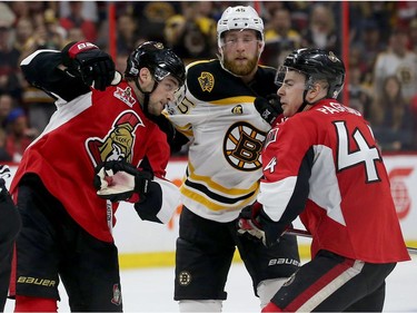 The Ottawa Senators and  Boston Bruins mix it up during the second period.