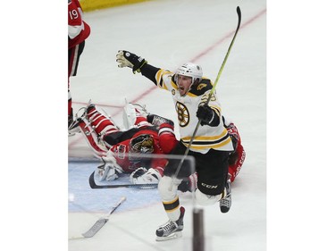 The Ottawa Senators' Craig Anderson and Erik Karlsson collide as the Boston Bruins' Tim Schaller scores during second period.