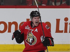 The Senators' Dion Phaneuf has reason to smile after scoring the overtime-winning goal against the Bruins on Saturday. The Senators won 4-3.