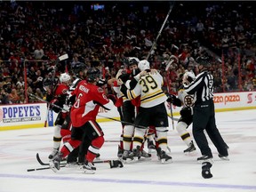 Senators and Bruins players get into a brief mix-up during the second period of Saturday's game. Tony Caldwell/Postmedia