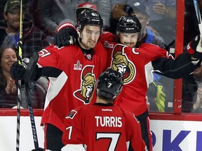 The Senators' Erik Karlsson celebrates his goal against Detroit with Mark Stone and Kyle Turris on Tuesday, April 4, 2017.