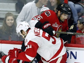 Ottawa Senators' Clarke MacArthur (16)gets checked by Detroit Red Wings' Frans Nielsen (51) during second period NHL hockey action in Ottawa on Tuesday, April 4, 2017.
