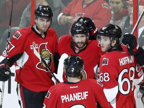 Ben Harpur, left, celebrates a Senators goal with teammates on Tuesday night. 'The injuries here are unfortunate, but for a guy like me … this is how guys jump-start their careers,' he said. 'This is how they get their opportunities. And you have to make the most of it.'