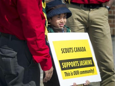 Six year old Rayyan Hameed, a Beaver Scout, held his sign proudly at a community safety march on Jasmine Crescent Sunday April 9, 2017.   Ashley Fraser/Postmedia