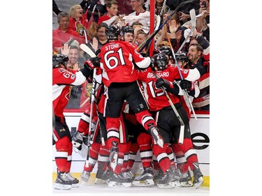 Soewhere under the pile is Jean-Gabriel Pageau as he is  congratulated on his winning goal.