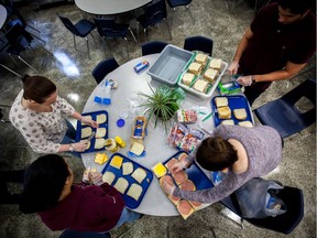 Students from the University of Ottawa volunteer at the Ottawa Mission making sandwiches.