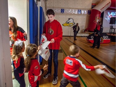 Students at A. Lorne Cassidy Elementary School receive Senators towels before welcoming former players Chris Phillips and Shaun Van Allen to talk about the Sens in School program and to get the kids excited for the playoffs.