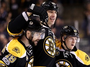 The Bruins' Zdeno Chara celebrates with Drew Stafford, left, and Torey Krug, right, after scoring against the Tampa Bay Lightning on Tuesday. Chara may not be as dominant as he once was, but he's still having a huge impact.